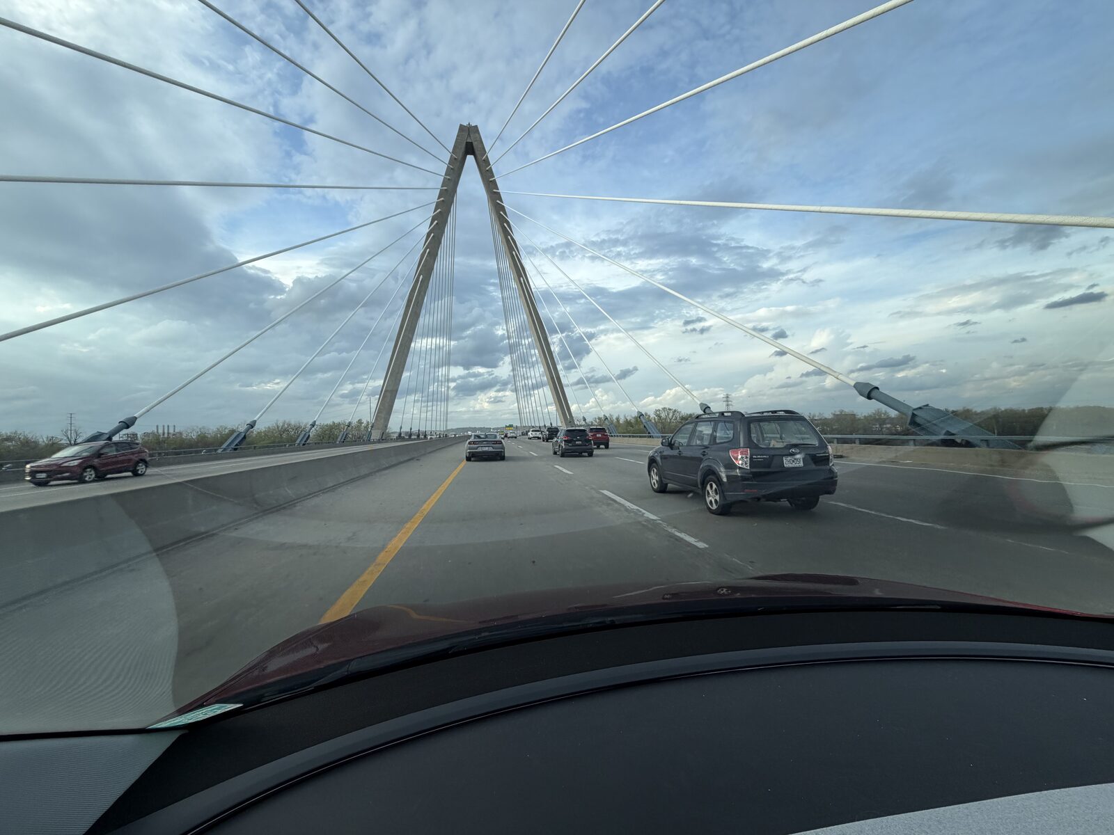 Driver's-seat view crossing the cable-stayed Christopher S. Bond Bridge on the I-29/I-35 stretch north of the Missouri River in Kansas City.