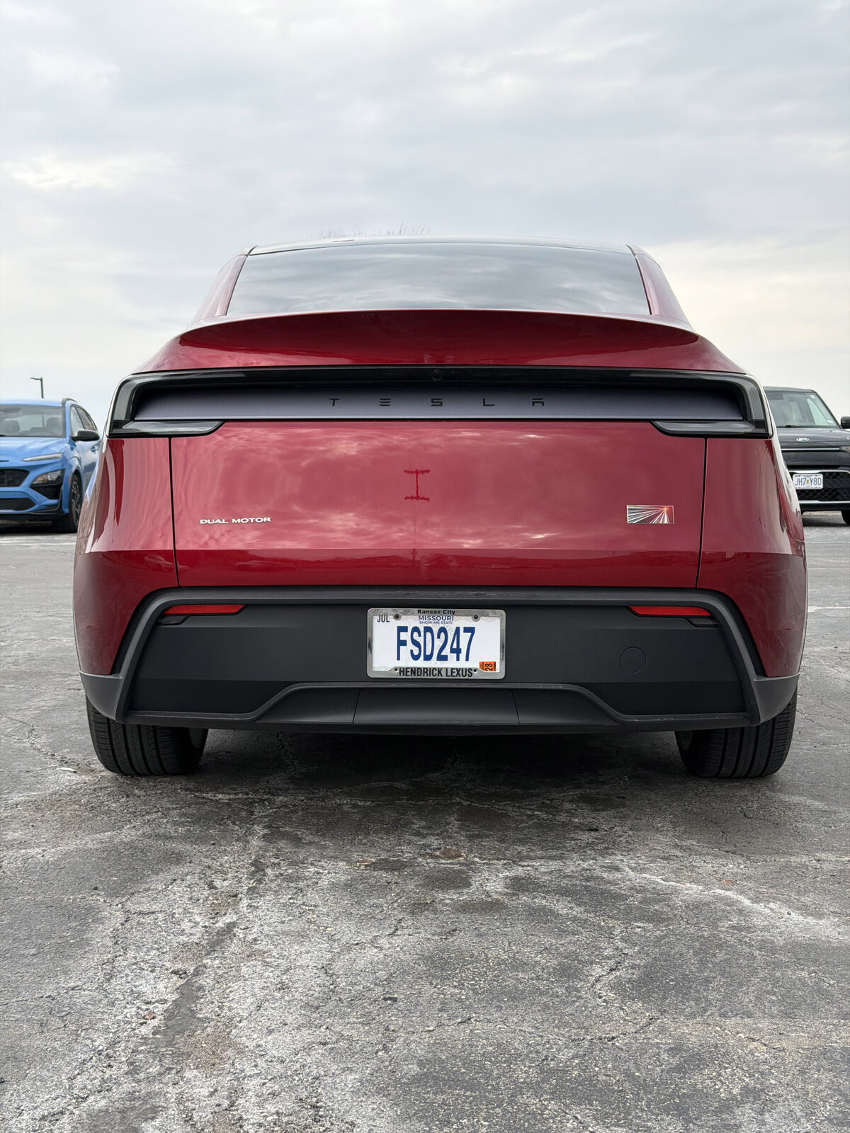 Rear of Roger's red Tesla Model Y with the Missouri FSD247 license plate.