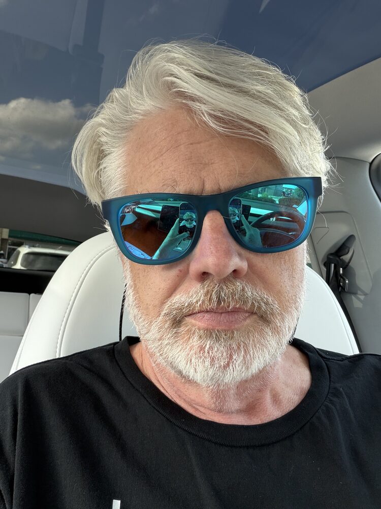 Roger Ridpath behind the wheel of his Tesla Model Y.