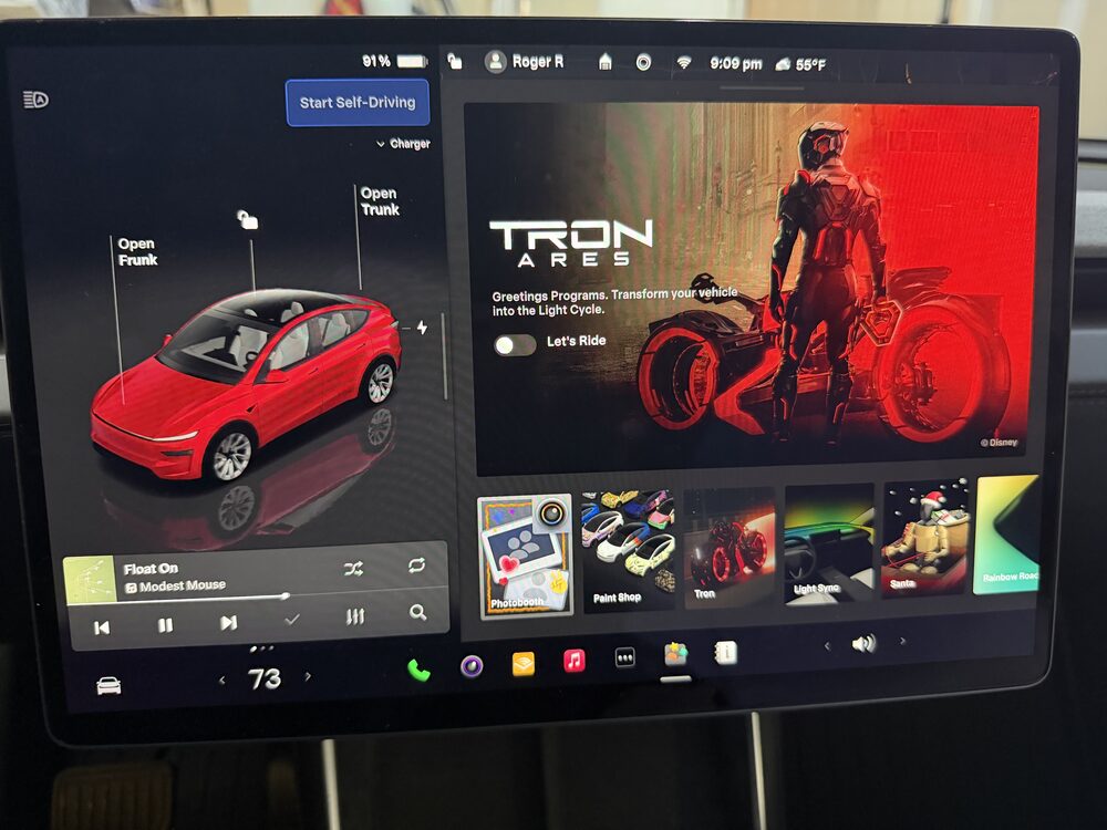 Tesla touchscreen showing the TRON: ARES theme.